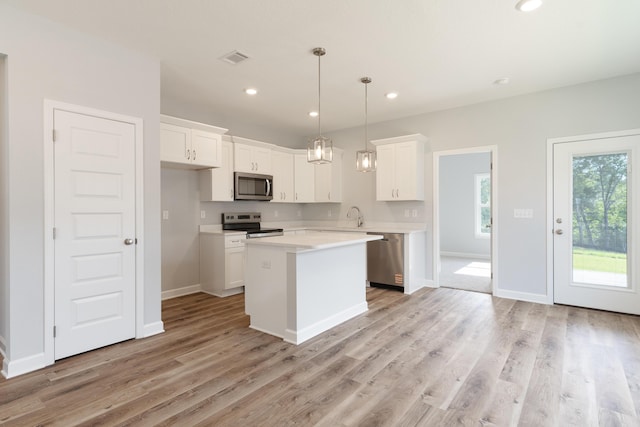 6119 Tansey St, Crestview, FL 32539 - kitchen featuring stainless steel appliances, white cabinets, light countertops, light wood-type flooring, and recessed lighting
