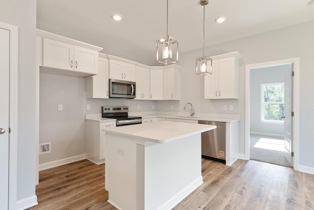 6119 Tansey St, Crestview, FL 32539 - kitchen with appliances with stainless steel finishes, a sink, light wood-style floors, white cabinetry, and light countertops