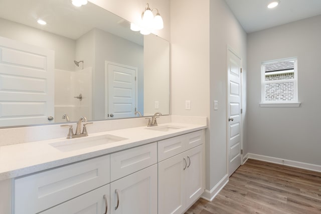 6119 Tansey St, Crestview, FL 32539 - bathroom with a shower, wood finished floors, double vanity, baseboards, and recessed lighting