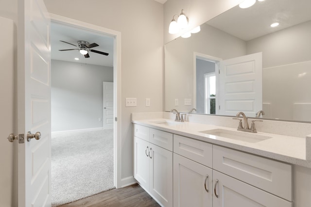 6119 Tansey St, Crestview, FL 32539 - bathroom featuring double vanity, baseboards, wood finished floors, a ceiling fan, and recessed lighting