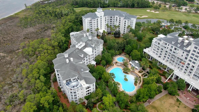 drone / aerial view featuring golf course view and a water view