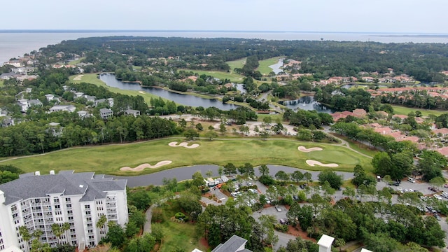 drone / aerial view with golf course view and a water view
