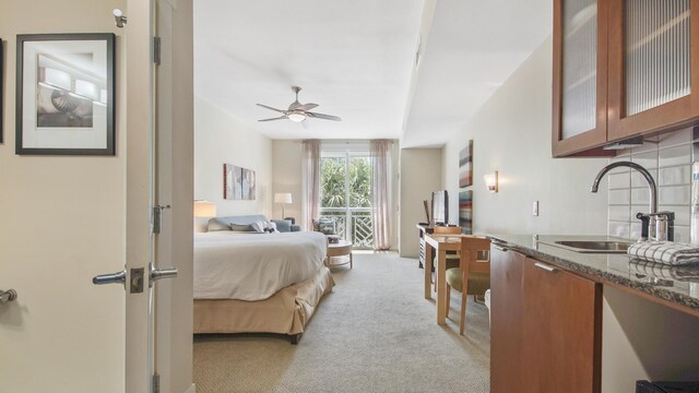 bedroom featuring a sink and light carpet