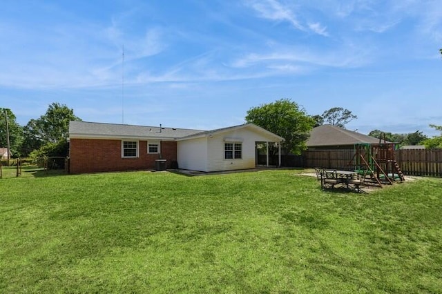 217 NW Martisa Rd, Fort Walton Beach, FL 32548 - back of house featuring a playground and central air condition unit
