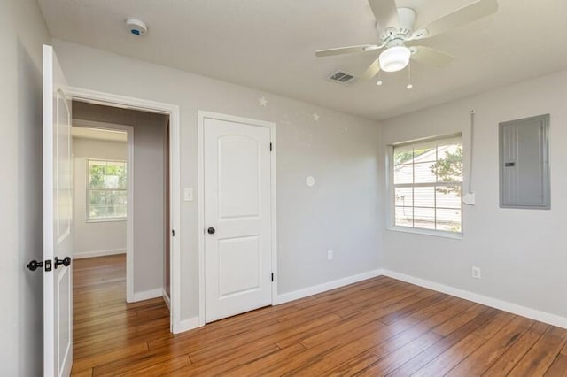 217 NW Martisa Rd, Fort Walton Beach, FL 32548 - empty room with electric panel, light wood finished floors, a ceiling fan, and baseboards