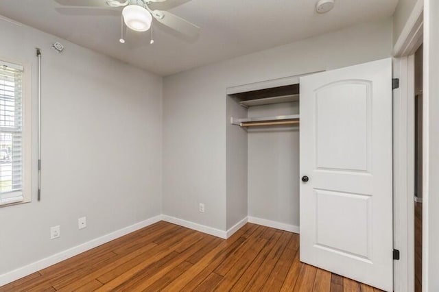 217 NW Martisa Rd, Fort Walton Beach, FL 32548 - unfurnished bedroom featuring wood finished floors, baseboards, a closet, and a ceiling fan