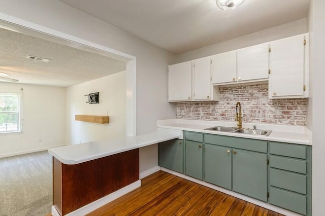 217 NW Martisa Rd, Fort Walton Beach, FL 32548 - kitchen featuring a sink, white cabinetry, a peninsula, and light countertops