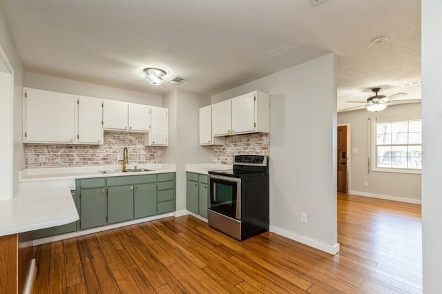 217 NW Martisa Rd, Fort Walton Beach, FL 32548 - kitchen featuring stainless steel electric stove, a sink, decorative backsplash, and dark wood finished floors