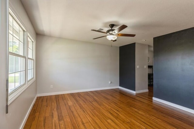 217 NW Martisa Rd, Fort Walton Beach, FL 32548 - spare room with wood finished floors, healthy amount of natural light, a ceiling fan, and baseboards