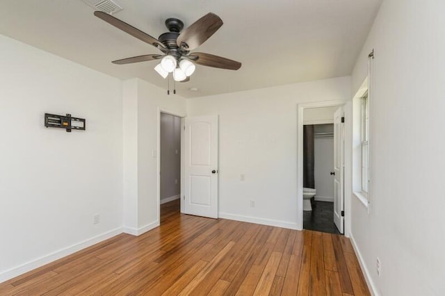 217 NW Martisa Rd, Fort Walton Beach, FL 32548 - unfurnished bedroom with light wood-style flooring, baseboards, connected bathroom, and ceiling fan