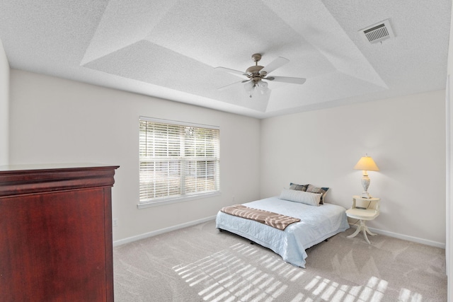 carpeted bedroom featuring baseboards, visible vents, and ceiling fan