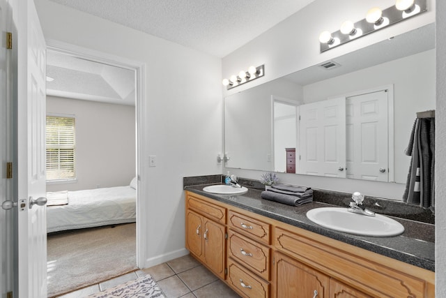 full bath with double vanity, a sink, tile patterned floors, and visible vents