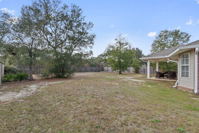 view of yard featuring a patio area and a fenced backyard