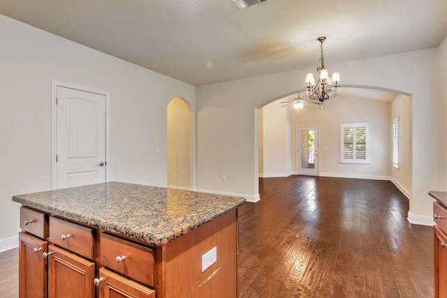 256 Cocobolo Dr, Santa Rosa Beach, FL 32459 - interior space with dark wood finished floors, arched walkways, and brown cabinets