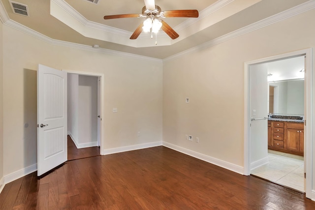 256 Cocobolo Dr, Santa Rosa Beach, FL 32459 - empty room with a tray ceiling, visible vents, wood finished floors, ceiling fan, and crown molding
