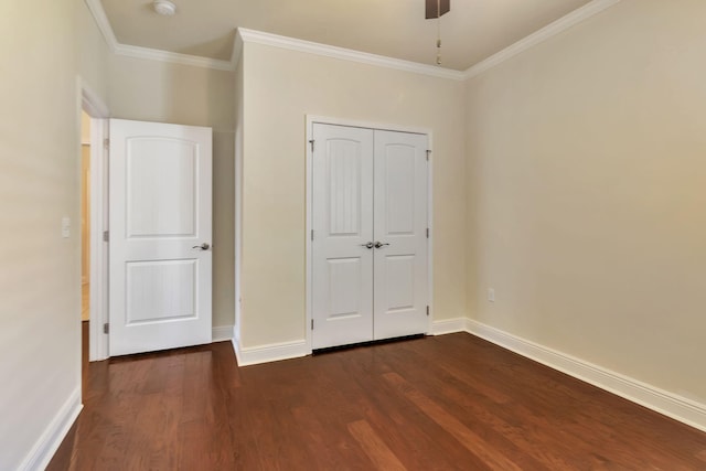 256 Cocobolo Dr, Santa Rosa Beach, FL 32459 - unfurnished bedroom with crown molding, a closet, ceiling fan, baseboards, and dark wood-type flooring