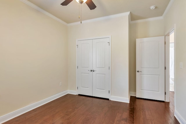 256 Cocobolo Dr, Santa Rosa Beach, FL 32459 - unfurnished bedroom featuring ornamental molding, baseboards, dark wood-style flooring, and a closet