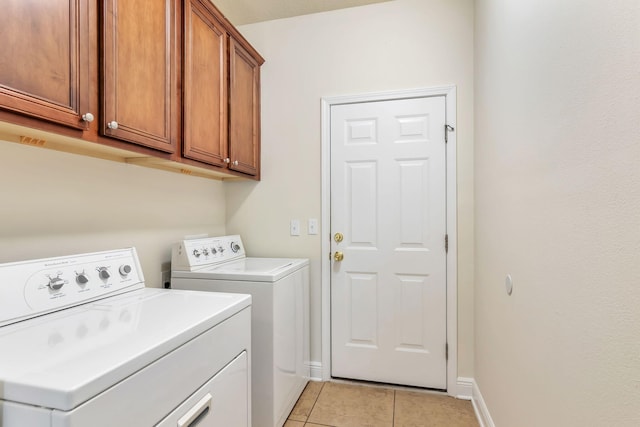 256 Cocobolo Dr, Santa Rosa Beach, FL 32459 - clothes washing area featuring washing machine and dryer, baseboards, cabinet space, and light tile patterned floors