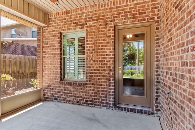 256 Cocobolo Dr, Santa Rosa Beach, FL 32459 - doorway to property featuring brick siding and fence