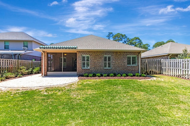 256 Cocobolo Dr, Santa Rosa Beach, FL 32459 - rear view of property featuring a fenced backyard, brick siding, a patio area, a yard, and a sunroom