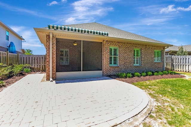 256 Cocobolo Dr, Santa Rosa Beach, FL 32459 - back of house with brick siding, a patio area, and a fenced backyard