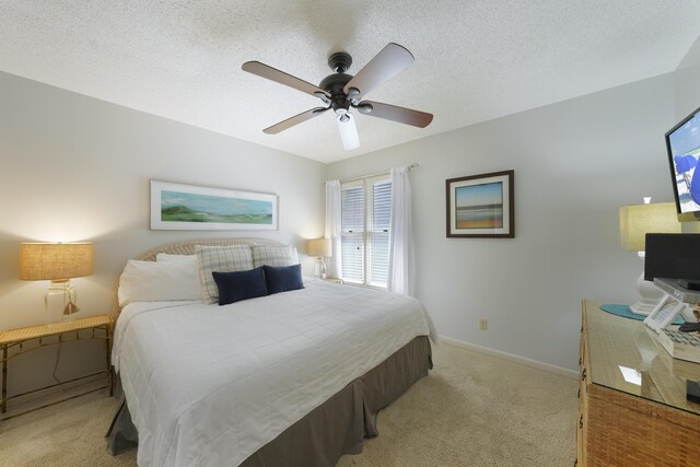 9815 W US Highway 98 Unit 215, Miramar Beach, FL 32550 - bedroom with light carpet, baseboards, a ceiling fan, and a textured ceiling