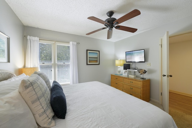 9815 W US Highway 98 Unit 215, Miramar Beach, FL 32550 - bedroom with a textured ceiling, baseboards, and a ceiling fan