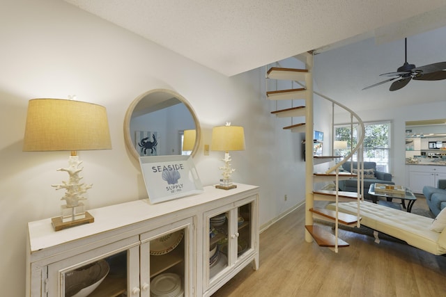 9815 W US Highway 98 Unit 215, Miramar Beach, FL 32550 - corridor with a textured ceiling, stairway, wood finished floors, and lofted ceiling