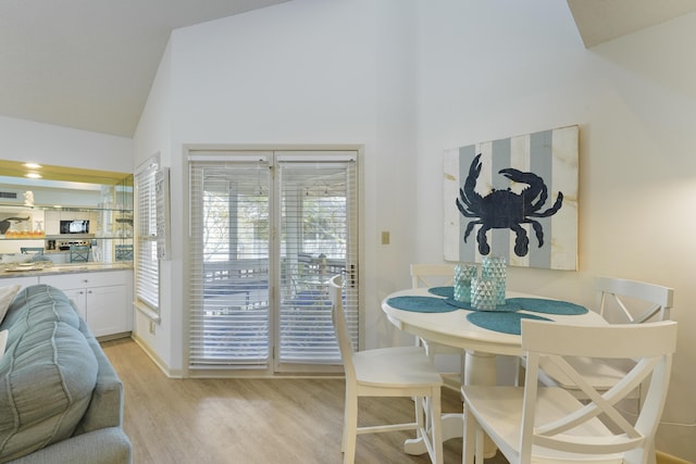9815 W US Highway 98 Unit 215, Miramar Beach, FL 32550 - dining room with high vaulted ceiling, visible vents, and light wood-type flooring