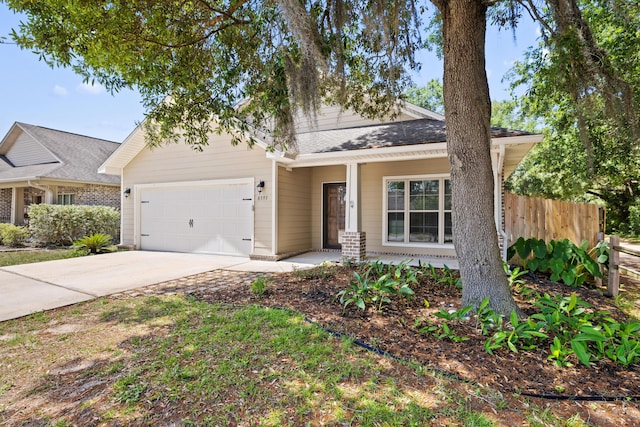 8393 New Orleans Ct, Navarre, FL 32566 - view of front of home featuring a garage, driveway, and a porch