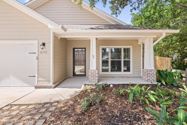 8393 New Orleans Ct, Navarre, FL 32566 - doorway to property with covered porch, an attached garage, brick siding, and roof with shingles