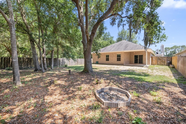 8393 New Orleans Ct, Navarre, FL 32566 - fenced backyard featuring an outdoor fire pit and a patio