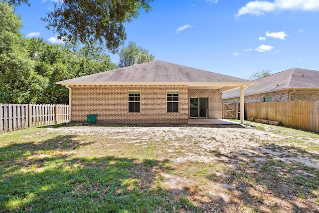8393 New Orleans Ct, Navarre, FL 32566 - rear view of house featuring a patio, a fenced backyard, brick siding, and a shingled roof