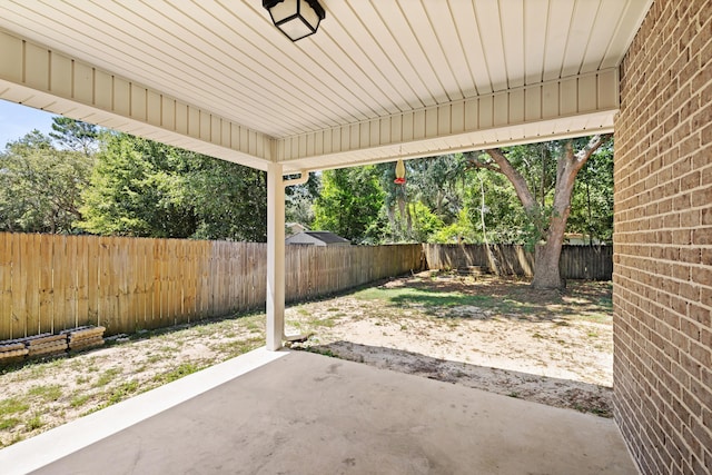 8393 New Orleans Ct, Navarre, FL 32566 - fenced backyard featuring a patio area and view of wooded area