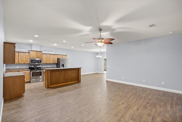 8393 New Orleans Ct, Navarre, FL 32566 - kitchen featuring stainless steel appliances, open floor plan, a ceiling fan, a center island with sink, and baseboards