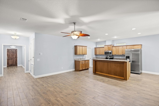 8393 New Orleans Ct, Navarre, FL 32566 - kitchen with stainless steel appliances, baseboards, light wood finished floors, a ceiling fan, and recessed lighting