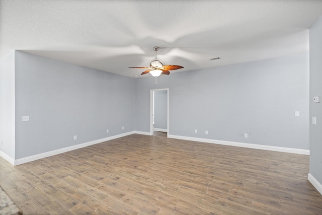 8393 New Orleans Ct, Navarre, FL 32566 - unfurnished room with ceiling fan, wood finished floors, baseboards, and a textured ceiling