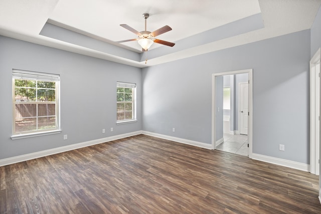 8393 New Orleans Ct, Navarre, FL 32566 - unfurnished room featuring a raised ceiling, healthy amount of natural light, ceiling fan, and wood finished floors