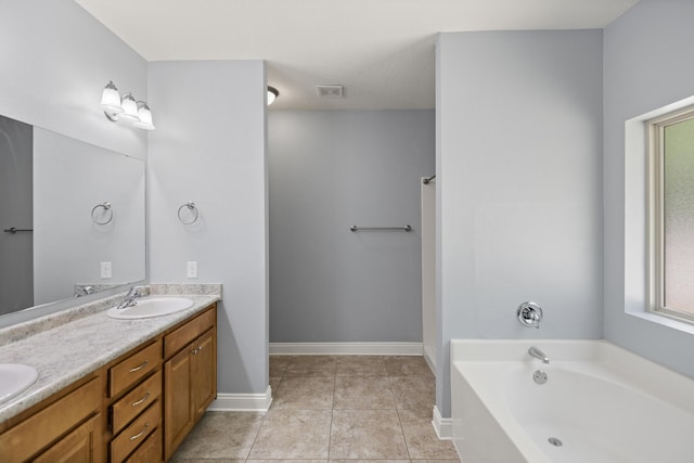 8393 New Orleans Ct, Navarre, FL 32566 - full bath with double vanity, a garden tub, tile patterned flooring, and baseboards