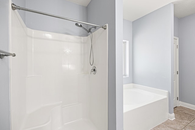 8393 New Orleans Ct, Navarre, FL 32566 - bathroom featuring a bath, a shower, tile patterned floors, and baseboards