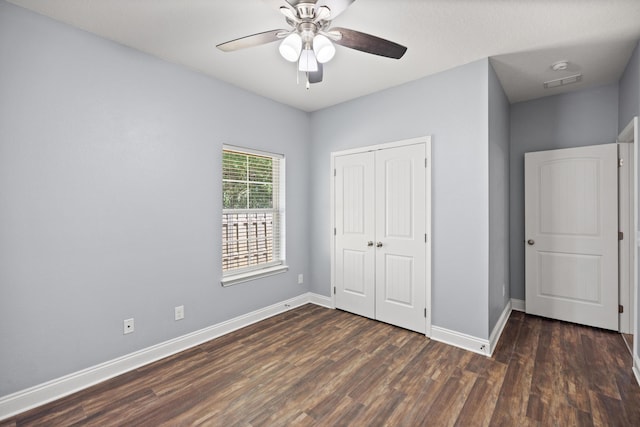8393 New Orleans Ct, Navarre, FL 32566 - unfurnished bedroom with dark wood-type flooring, baseboards, a closet, and a ceiling fan