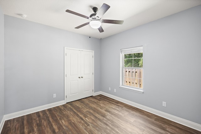 8393 New Orleans Ct, Navarre, FL 32566 - unfurnished bedroom with dark wood-type flooring and baseboards