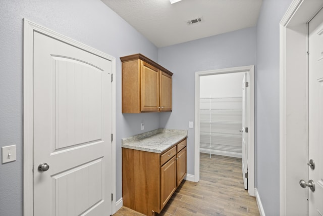 8393 New Orleans Ct, Navarre, FL 32566 - laundry area with light wood-style flooring and baseboards