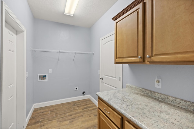 8393 New Orleans Ct, Navarre, FL 32566 - washroom with washer hookup, wood finished floors, cabinet space, baseboards, and electric dryer hookup