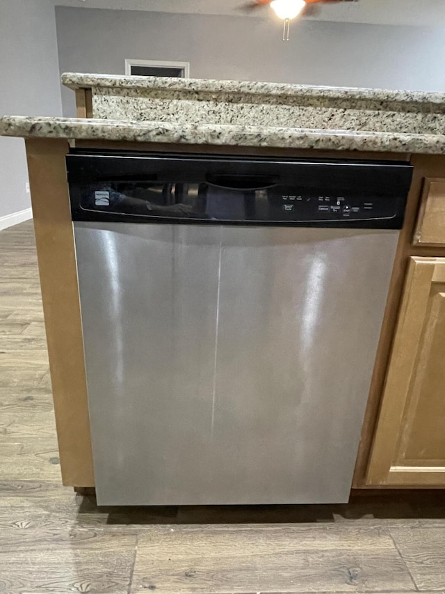 8393 New Orleans Ct, Navarre, FL 32566 - kitchen view of stainless steel dishwasher, light wood-style flooring, ceiling fan, and light stone counters