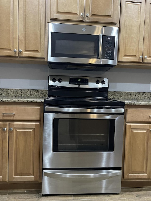 8393 New Orleans Ct, Navarre, FL 32566 - kitchen with stainless steel appliances, light stone counters, and light wood finished floors