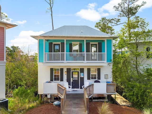 198 Somerset Bridge Rd Unit 117, Santa Rosa Beach, FL 32459 - view of front facade featuring covered porch, stucco siding, a balcony, metal roof, and central AC