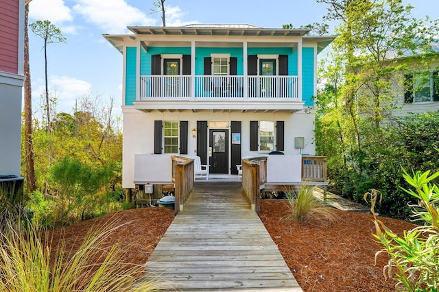 198 Somerset Bridge Rd Unit 117, Santa Rosa Beach, FL 32459 - view of front of house with a balcony, stucco siding, and a porch