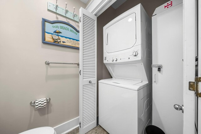 198 Somerset Bridge Rd Unit 117, Santa Rosa Beach, FL 32459 - washroom with stacked washer and dryer, baseboards, and laundry area