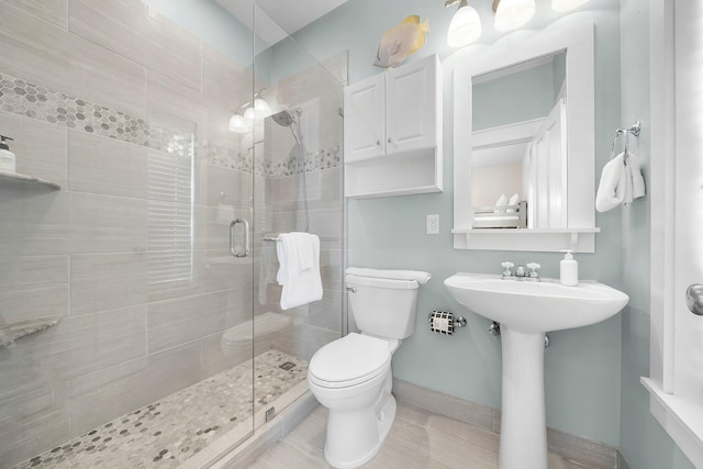 198 Somerset Bridge Rd Unit 117, Santa Rosa Beach, FL 32459 - bathroom featuring baseboards, toilet, a stall shower, and a sink